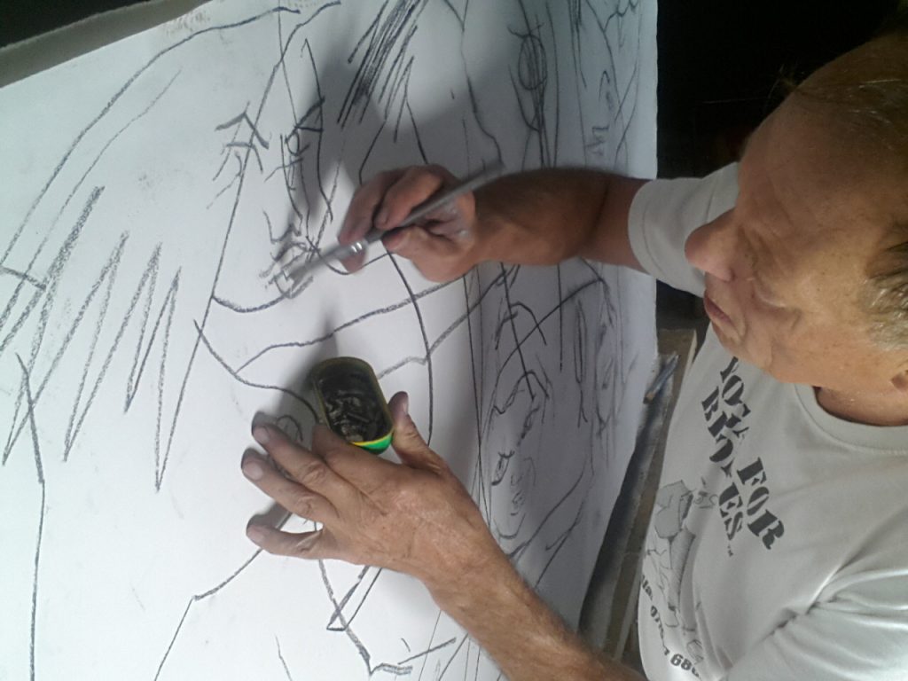 Alan Dedman pouncing charcoal through a cartoon Les Dems